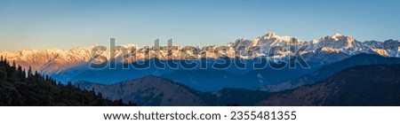 Panoramic view during sunset over snow cladded gangotri group mountain peaks falls in Greater Himalayas mountain range from Chopta, Uttarakhand, India.