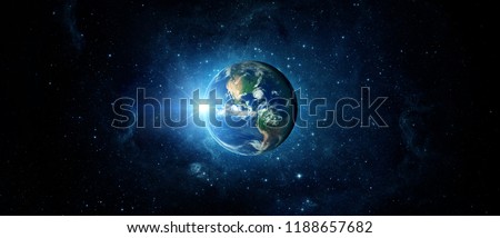 Panoramic view of the Earth, sun, star and galaxy. Sunrise over planet Earth, view from space.
