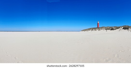 Panoramic view of an empty beach with a red lighthouse