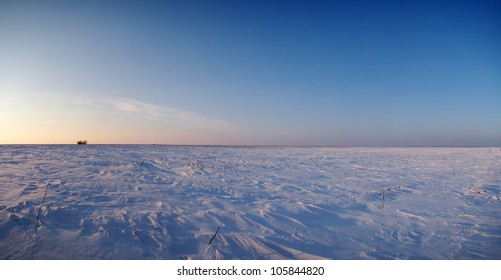 Panoramic View Of An Empty Field Covered By A Recent Blizzard. The Strong Wind Has Sculpted Snow Dunes In The Desolate Landscape.