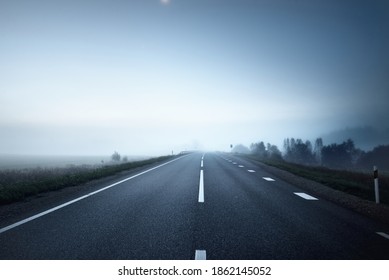 Panoramic view of the empty highway through the fields in a fog at night. Moonlight, clear sky. Rural scene - Powered by Shutterstock