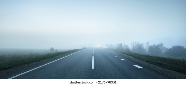 Panoramic view of the empty highway through the fields in a fog at night. Moonlight, clear sky. Sunrise. Europe. Transportation, logistics, travel, road trip, freedom, driving. Rural scene - Powered by Shutterstock