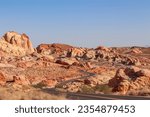 Panoramic view of endless winding empty road in Valley of Fire State Park leading to red Aztec Sandstone Rock formations and desert vegetation in Mojave desert, Overton, Nevada, USA. Freedom road trip
