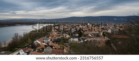 A panoramic view of Esztergom, a Hungarian city on the bank of the Danube river, on a hazy, overcast winter day.