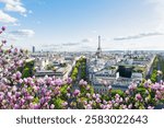 panoramic view of famous Eiffel Tower and Paris roofs with spring flowers, Paris France