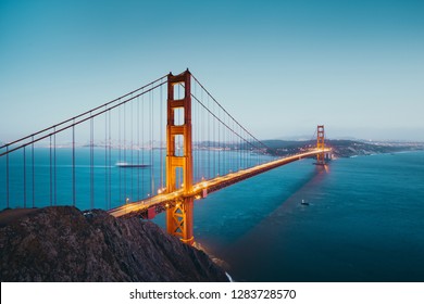 Panoramic view of famous Golden Gate Bridge seen from Battery Spencer viewpoint in beautiful post sunset twilight during blue hour at dusk, San Francisco, USA
