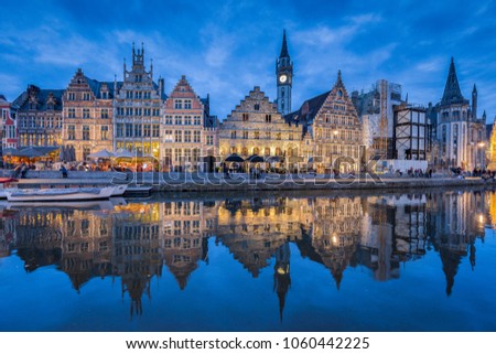 Panoramic view of famous Graslei in the historic city center of Ghent illuminated in beautiful post sunset twilight during blue hour at dusk with Leie river, Ghent, East Flanders, Belgium