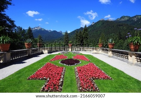 Panoramic view of the flowerbed, forest and mountains in Linderhof.