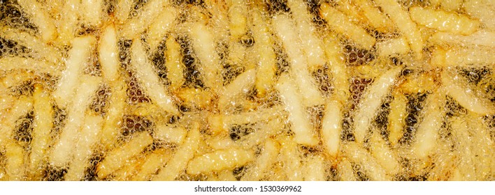 Panoramic view of French fries deep fried in bubbles - Powered by Shutterstock