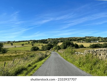 Panoramic view from, Smalden Lane of the Lancashire countryside, with dry stone walls, wild plants, fields and hills,in Grindleton, UK