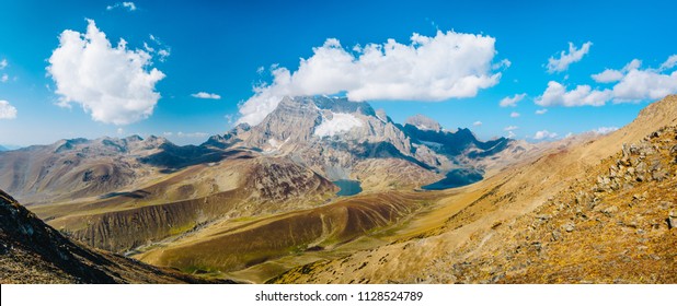 Panoramic view of Gangabal lakes in dry season from Zajibal Pass (4,100m) with Mount Harmukh and blue sky in background from Kashmir The Great Lakes Trek, India.