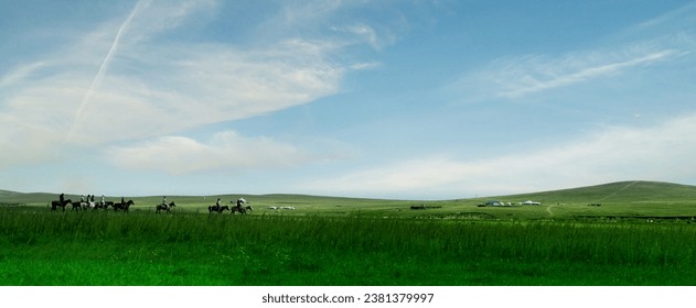panoramic view of geometric patchwork of gardens, agricultural lands, farmland in springtime
