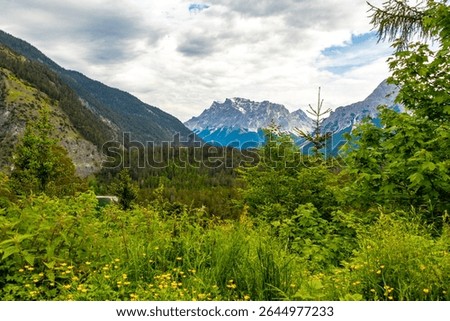 Panoramic view of Germanys largest mountain Zugspitze alpine landscape with turquoise Blindsee lake forest rocks hills and mountains in the Alps Biberwier Reutte Tyrol Austria.