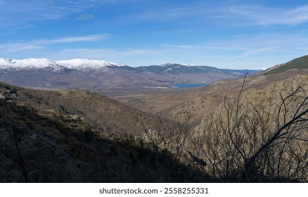 Panoramic view going up to the Morcuera pass and in the background the Pinilla reservoir and some of the most important snow-capped mountains. Madrid. 