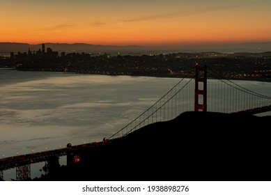 Panoramic view of the Golden Gate Bridge in the sunrise viewed from  Slacker Hill, featuring orange, warm colors