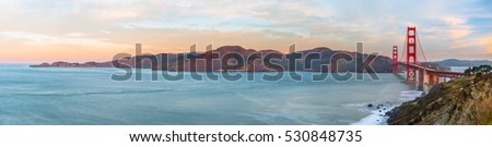 Panoramic view of the Golden Gate Bridge at sunrise from the Battery Godfrey overlook. 