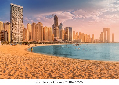 Panoramic view of the golden sand illuminated by the setting sun in the JBR beach area. Amazing skyscrapers and warm waters of the Persian Gulf are waiting for guests and tourists