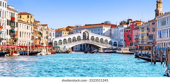 Panoramic view of Grand Canal with Rialto Bridge and gondoliers in Venice, Italy. Panorama of Rialto Bridge and gondola on the Grand Canal in Venice, Italy, Europe.  - Powered by Shutterstock