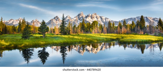 Panoramic view of Grand Teton range in Grand Teton National Park. Grand Teton National Park is in Wyoming, USA. Also, Grand Teton range is a range of mountains part of the US Rockies. - Powered by Shutterstock