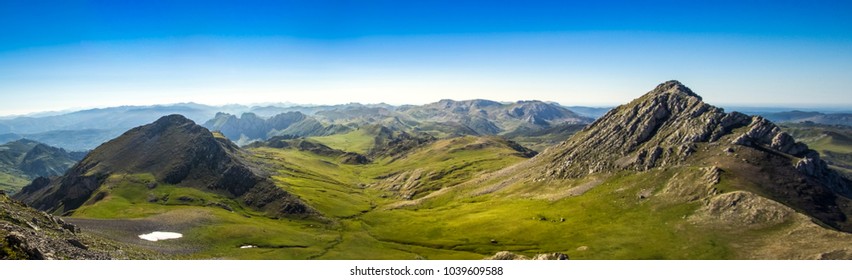 panoramic view of green fields whit montains in north spain south europe asturias cordillera cantabrica 