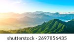 Panoramic view of the green mountain range and forest with beautiful mist natural landscape at sunrise