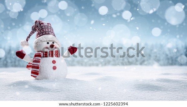 Panoramic view of happy snowman in winter scenery\
with copy space