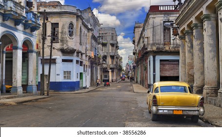 Panoramic view of Havana street with crumbling buildings and old classic car - Powered by Shutterstock