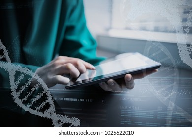 Panoramic view of helix pattern information on device screen against midsection of surgeon using digital tablet