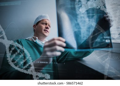 Panoramic view of helix pattern information on device screen against surgeon sitting at window and checking x-ray