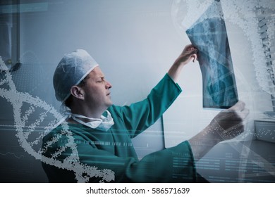 Panoramic view of helix pattern information on device screen against surgeon sitting at window and checking x-ray