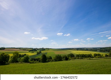 Panoramic view of the hilly landscape of Limburg with farmland and newly planted crops close to the city of Valkenburg, the Netherlands; against a clear blue sky - Shutterstock ID 1746432572