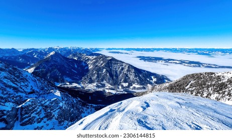 Panoramic view from Hochobir on snow capped mountain peaks of Karawanks in Carinthia, Austria. Julian Alps. Winter wonderland in the Austrian Alps, Europe. Valley covered with clouds. High Tauern Alps - Powered by Shutterstock