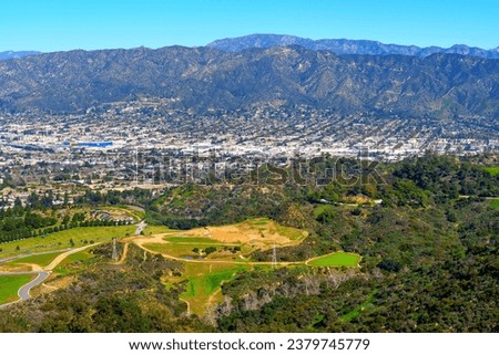 Panoramic view of the Hollywood Hills and the sprawling city of Los Angeles as seen from the vantage point near the iconic Hollywood Sign.