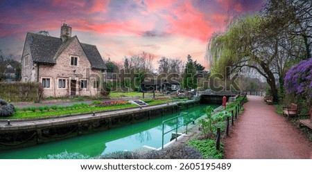 Panoramic view of Iffley Lock on the River Thames path at sunseth, with beautiful blooming gardens and fresh flowers in the springtime - Oxford, Oxfordshire, England