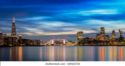 Panoramic view of illuminated London cityscape at sunset