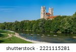 Panoramic view of the Isar River in Munich with the two towers of the Catholic Church of St. Maximilian under a cloudless, blue sky in summer