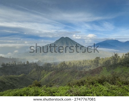 Panoramic view of Java green stratovolcano and forested ridges