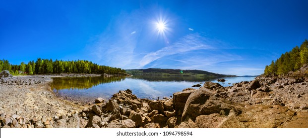 Panoramic View Of Mjøsa Lake, Rocky Shore, Forest, Blue Sunny Sky; Summer; Norway.