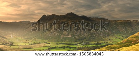 Panoramic view of the Langdale Pikes at sunset in the English Lake District.