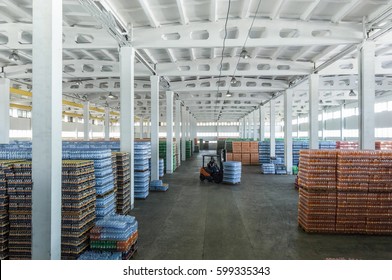 panoramic view of a large warehouse with drinks in plastic bottles with loading machines - Powered by Shutterstock