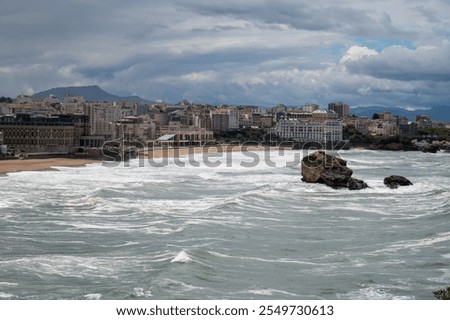 Panoramic view from lighthouse on cliffs, houses, sandy beaches of touristic Biarritz city, Basque Country, Bay of Biscay of Atlantic ocean, France, storm in Biarritz