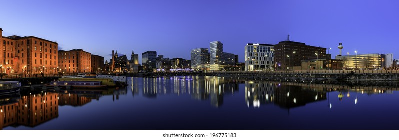 panoramic view of Liverpool skyline reflected in river Mersey at Albert dock