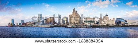 Panoramic view of Liverpool waterfront,  including modern office buildings and the River Mersey.