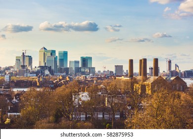 Panoramic view of London from Greenwich park at sunset. Residential buildings and houses on foreground, modern buildings on background. Architecture and travel concepts