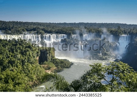 Panoramic view looking across to Adam and Eve Falls and Bossetti Falls on the Argentine side from the Brazil side of Iguazu Falls National Park, a UNESCO listed world heritage site.