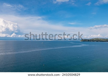 Panoramic view of majestic coastline of Gulf of Piran, Slovenian Istria, Slovenia, Europe. Overlook the shimmering azure waters of Mediterranean sea. Solitary Ship floating in bay, Adriatic Sea