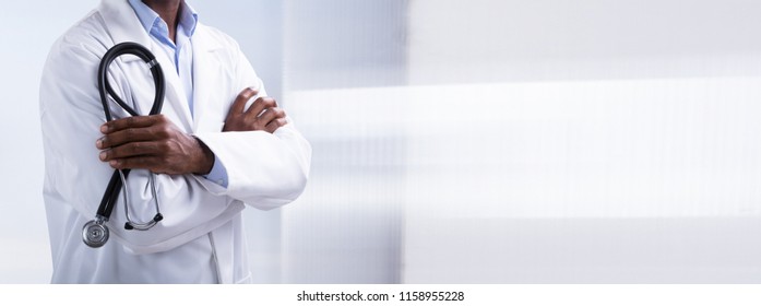 Panoramic View Of Male Doctor With Arms Crossed Holding Stethoscope