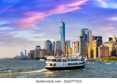 Panoramic view of Manhattan cityscape and ship ferry in New York City at sunset, NY, USA