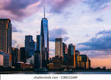 Panoramic View Of Manhattan Island With Sunset Reflection In Glass Buildings.Scenery Skyline View Of Contemporary Skyscrapers Of Downtown Financial District In New York. Gold Sunset Over NYC Cityscape