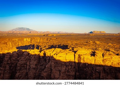 Panoramic view of Marble Canyon cliffs and Colorado River under warm sunset light from Spencer Trail Lookout